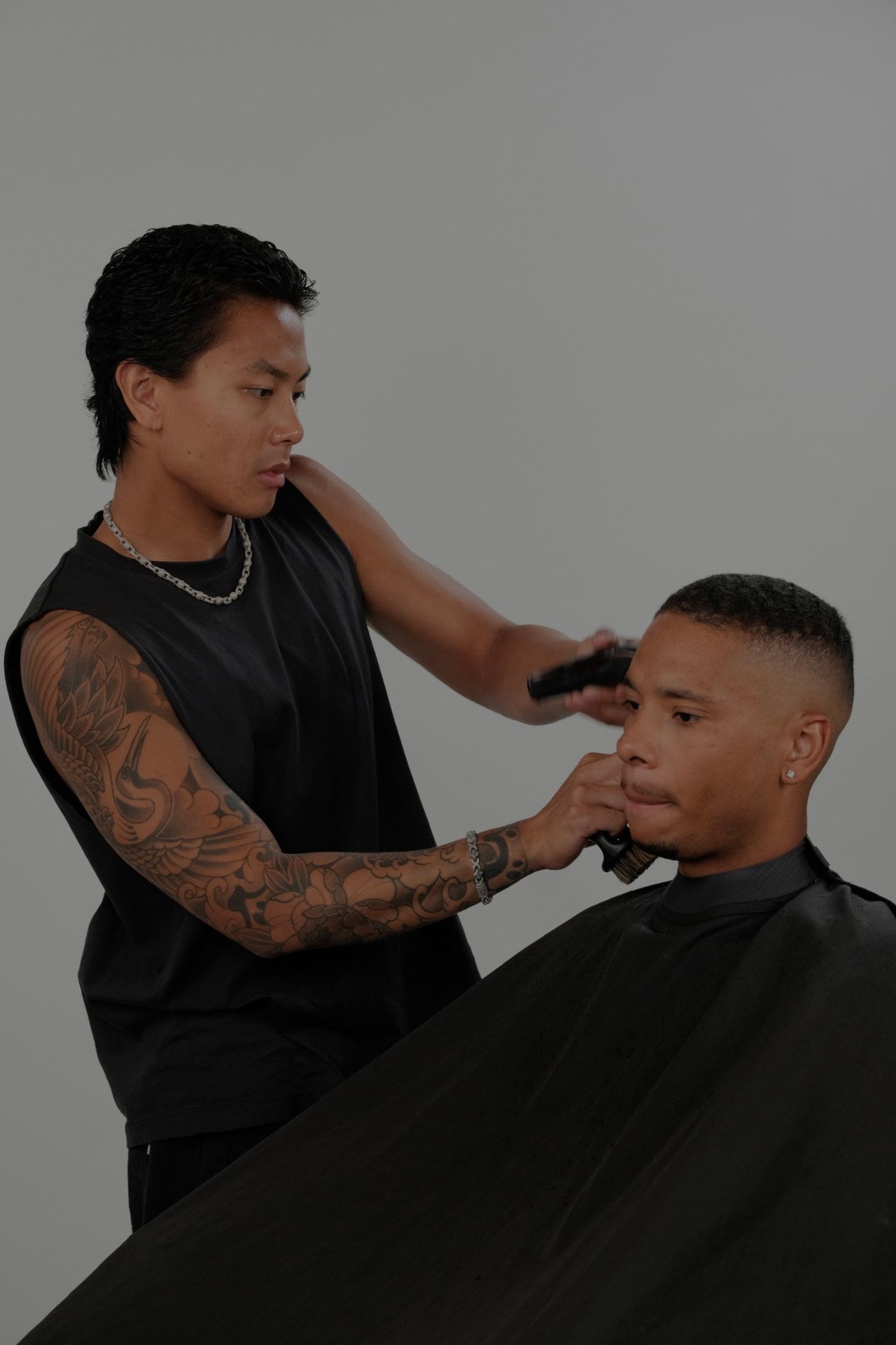A Studio M barber shaping a client’s hair